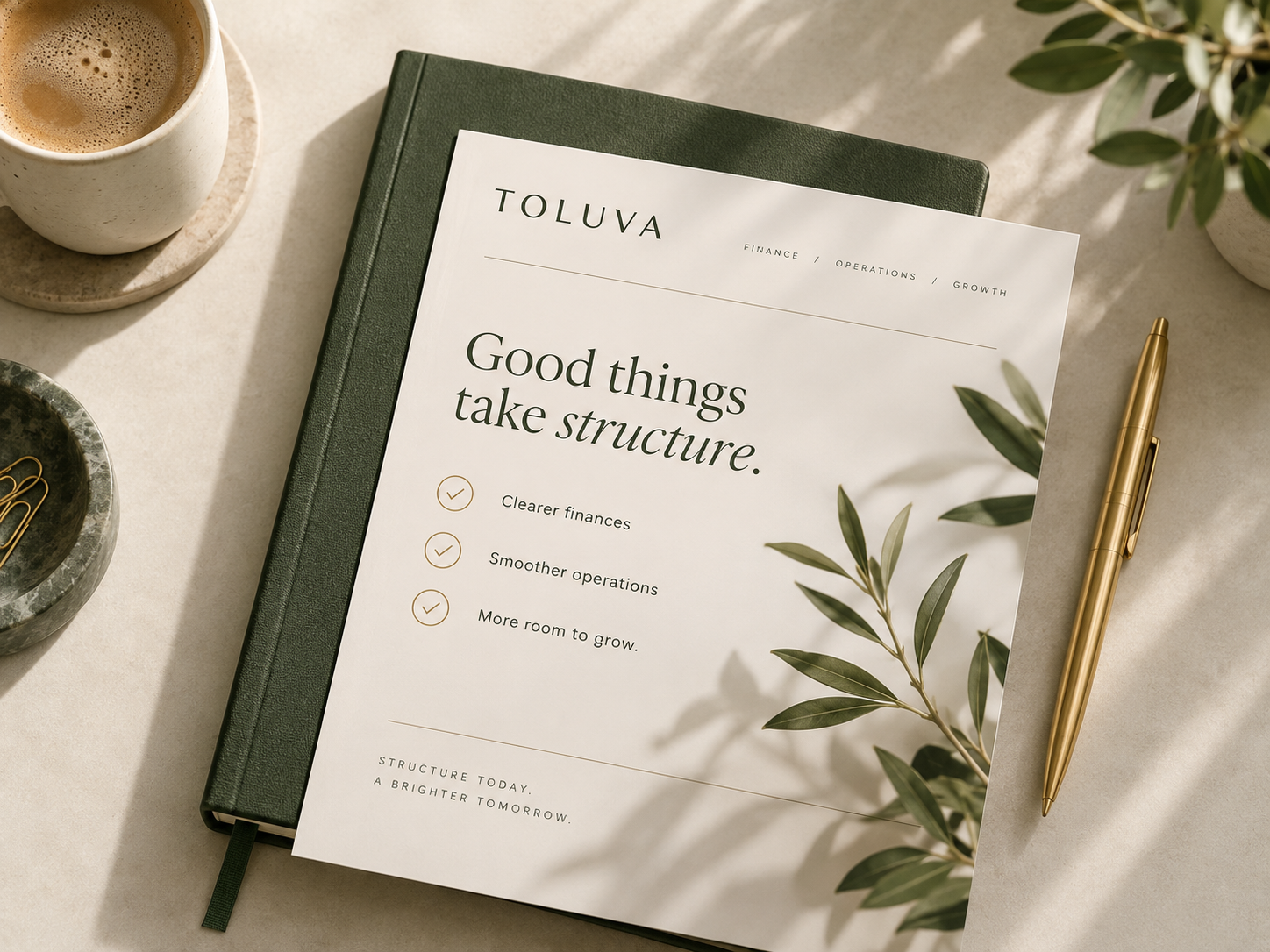 Toluva workspace with notebook, business planning sheet and gold pen
